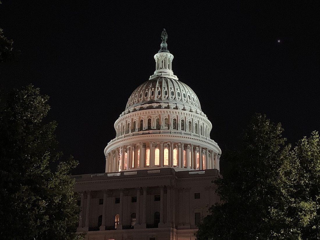 The United States Capitol dome illuminated at night